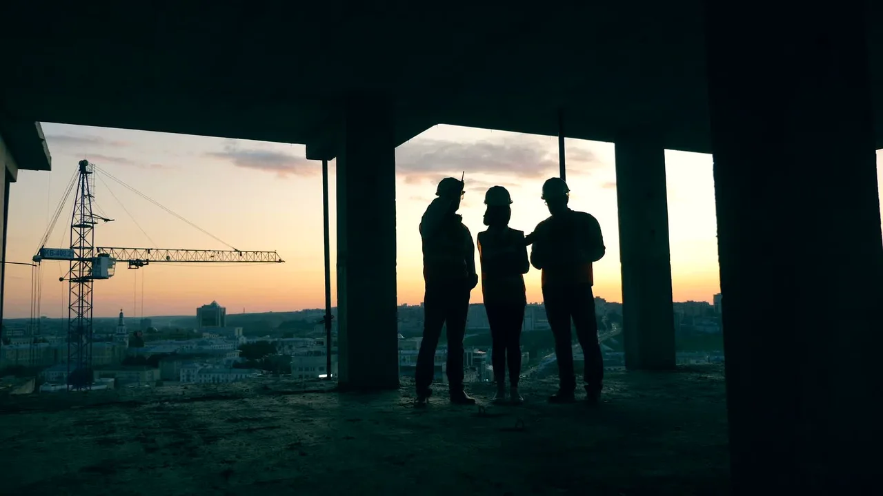 Project team silhouetted inside a commercial building under construction