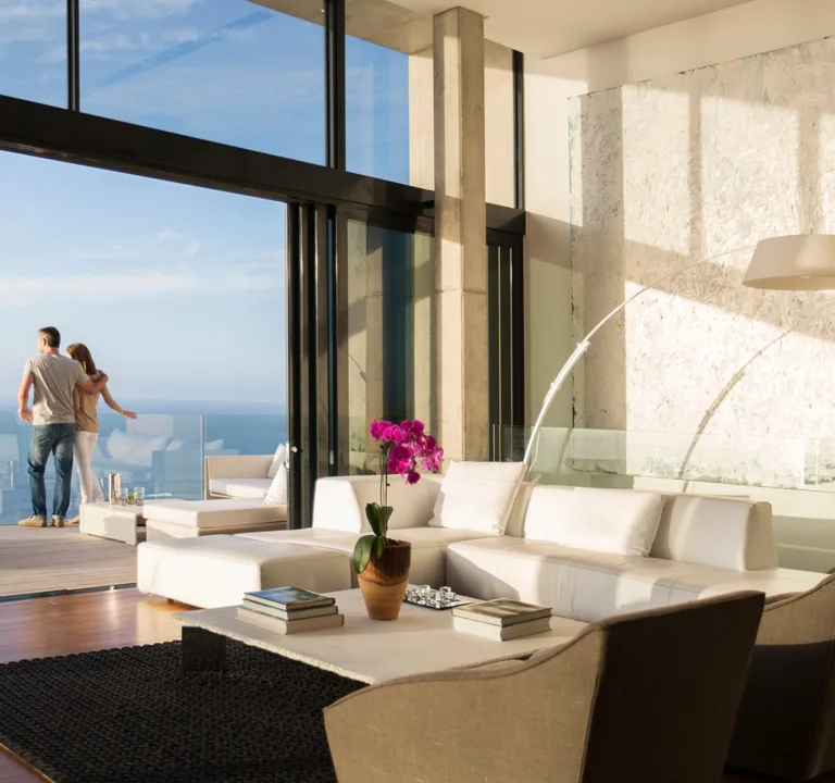 Couple looking out from a light-filled modern living room
